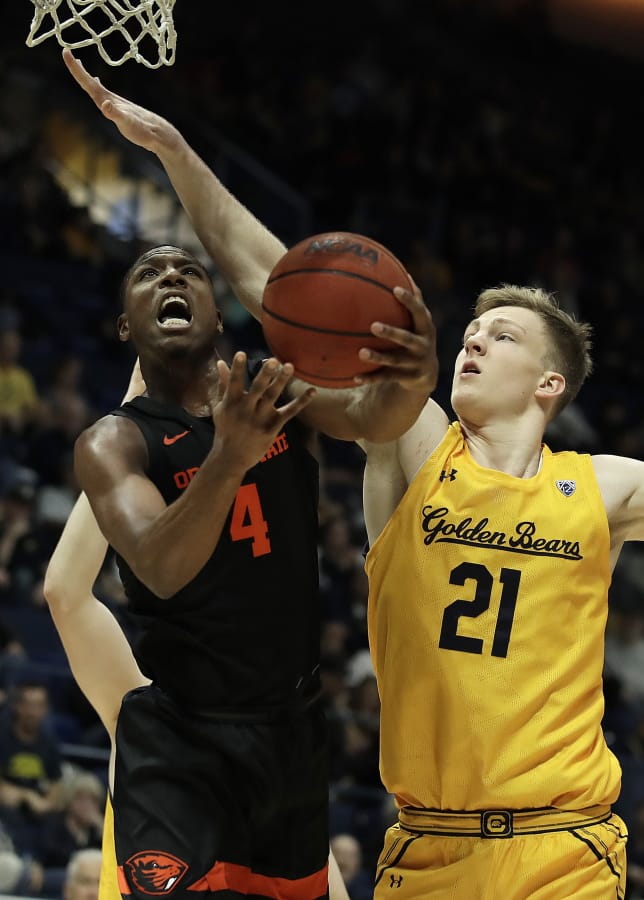 Oregon State&#039;s Alfred Hollins, left, shoots against California&#039;s Lars Thiemann (21) in the second half of an NCAA college basketball game Saturday, Feb. 1, 2020, in Berkeley, Calif.