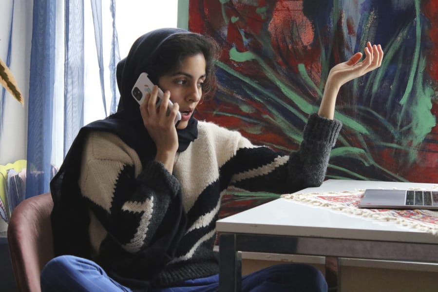 Iranian American activist Hoda Katebi, 24, speaks to another activist on Jan. 12, 2020 in her Chicago apartment. She and her network had received word that morning that an Iranian student was being detained at O&#039;Hare International Airport.