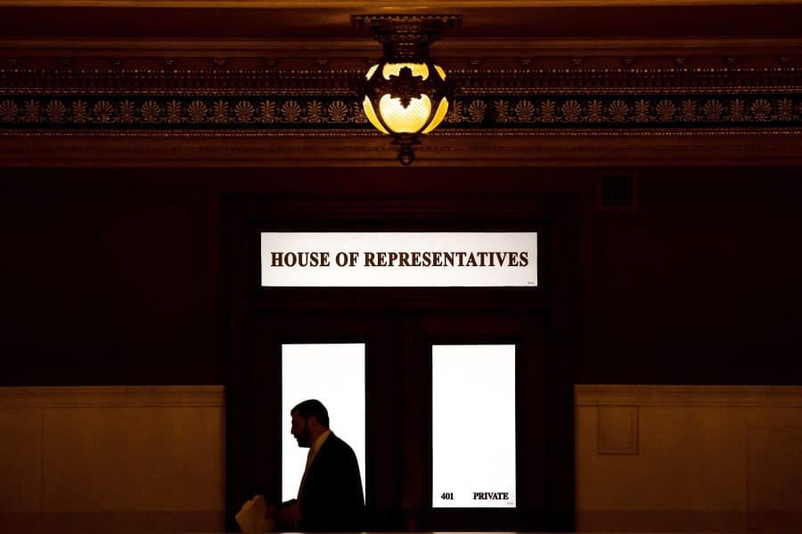 FILE - In this Nov. 20, 2019 file photo, a lawmaker is silhouetted as he walks past a window in the Pennsylvania Capitol in Harrisburg, Pa. While most states have not yet considered law changes to screen former clergy members who seek licenses for jobs that put them in contact with children, at least 20 state attorneys general are conducting investigations of how church officials handled abuse allegations, including reporting them to civil law enforcement, largely in the wake of the Pennsylvania attorney general office&#039;s 2018 grand jury report that looked at how abuse allegations were handled in six dioceses.