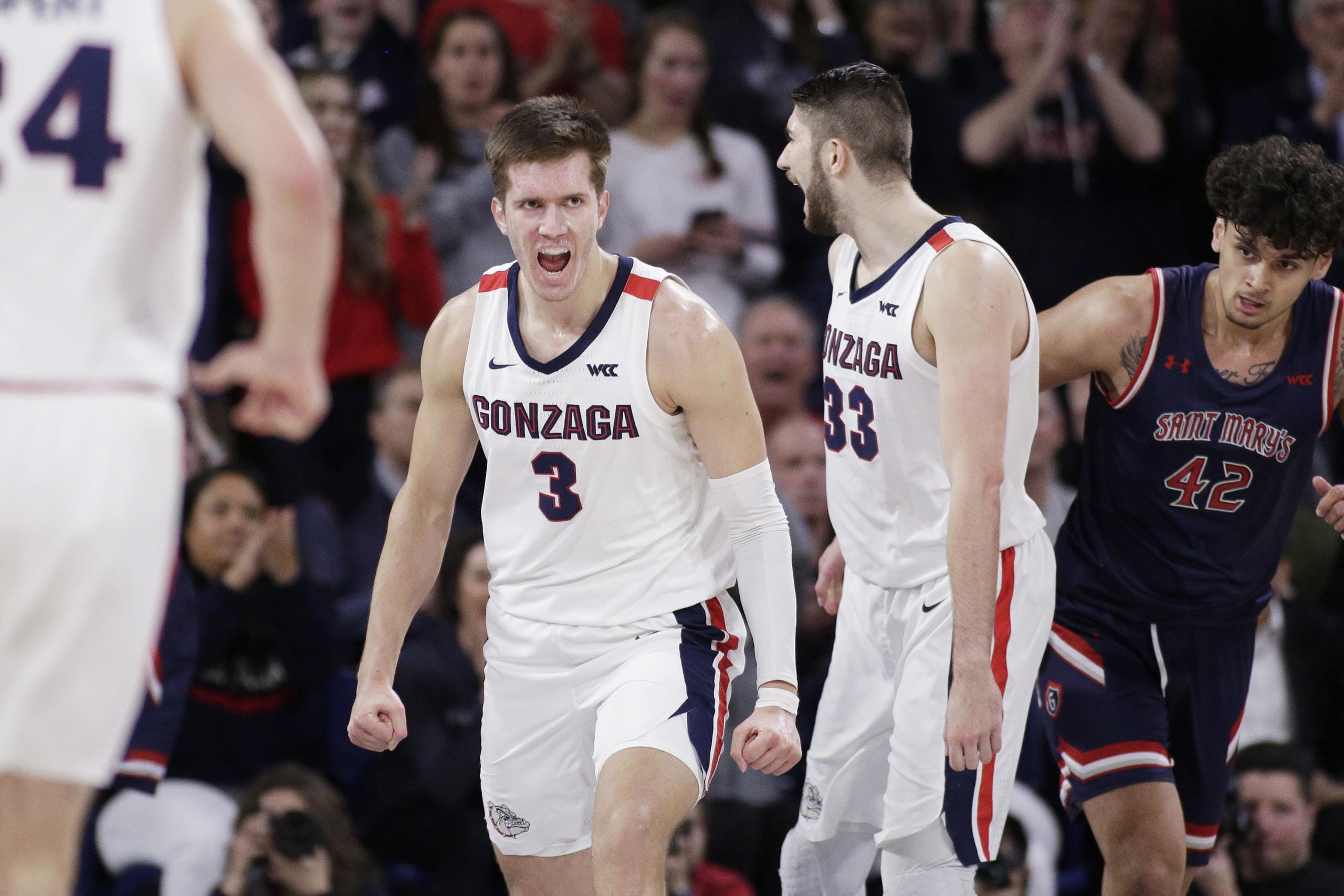Gonzaga forwards Filip Petrusev (3) and Killian Tillie (33) celebrate after Petrusev scored during the second half of the team's NCAA college basketball game against Saint Mary's in Spokane, Wash., Saturday, Feb. 29, 2020. Gonzaga won 86-76.