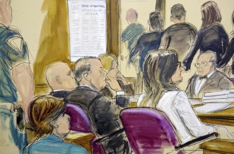 In this courtroom drawing, Harvey Weinstein, center, sits at the defense table surrounded by his attorneys as jurors file out of the courtroom after being told by the judge to go back and keep deliberating in Weinstein&#039;s rape case, Friday, Feb. 21, 2020, at Manhattan Supreme Court in New York. Earlier they sent out a note saying they were deadlocked on two charges. Attorney Gloria Allred, foreground left, is seated in the gallery behind Weinstein.