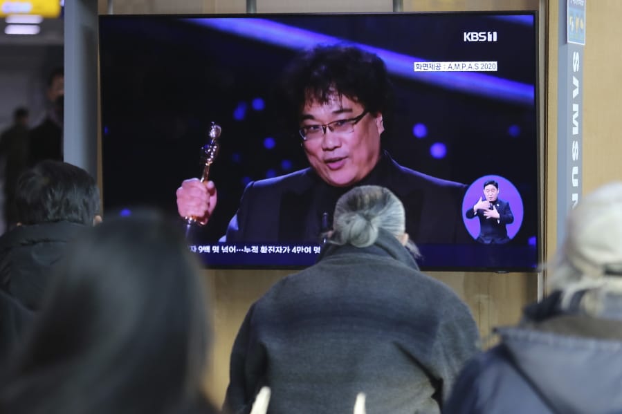 People watch a TV screen showing an image of South Korean director Bong Joon Ho during a news program at the Seoul Railway Station in Seoul, South Korea, Monday, Feb. 10, 2020. In a milestone win that instantly expanded the Oscars&#039; horizons, Bong&#039;s masterfully devious class satire &quot;Parasite&quot; became the first non-English language film to win best picture in the 92-year history of the Academy Awards.
