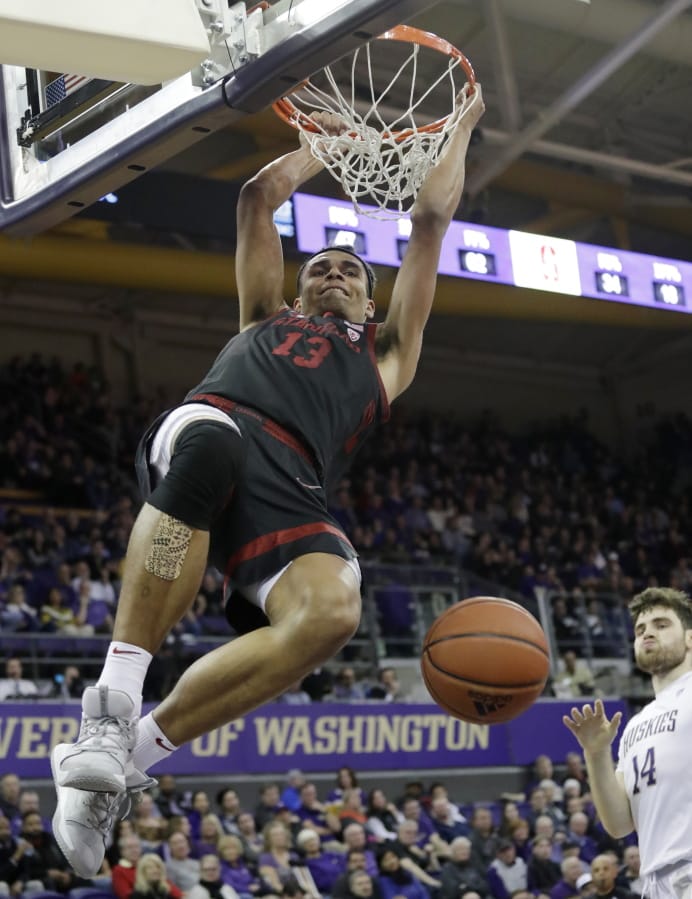 Stanford&#039;s Oscar da Silva hangs from the basket after dunking against Washington late in the second half of an NCAA college basketball game Thursday, Feb. 20, 2020, in Seattle. Stanford won 72-64.