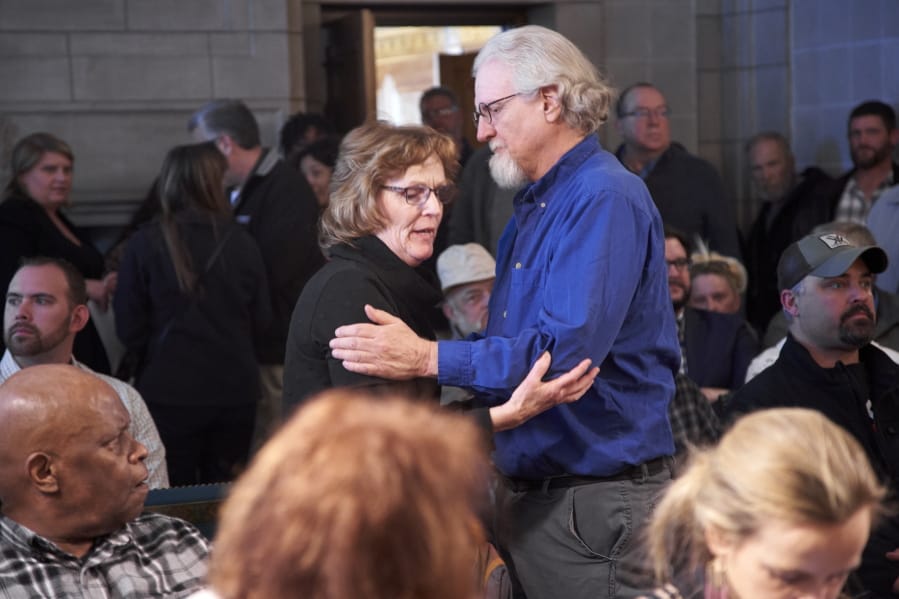 Paulette Neemann, left, and Dave Ellis, relatives of murdered victims of Charles Starkweather, hug in Lincoln, Neb., Tuesday, Feb. 18, 2020, before a hearing of he Nebraska Board of Pardons to consider a request for clemency from Caril Ann Clair, the 76-year-old former girlfriend of Charles Starkweather, who went on an infamous killing spree in Nebraska and Wyoming in the late 1950s. The pardon board voted 3-0 to deny the application from Clair.