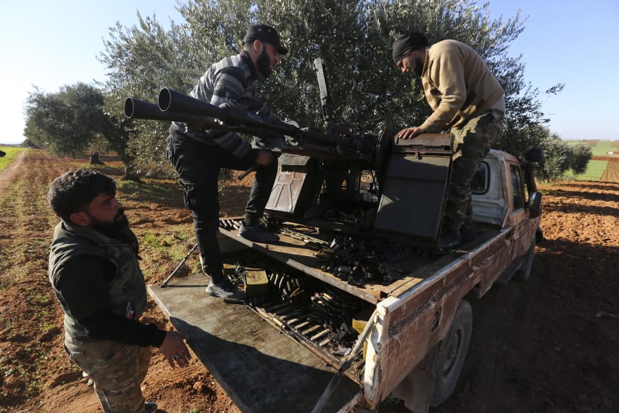 Turkish backed Syrian fighters load ammunition at a frontline near the town of Saraqib in Idlib province, Syria, Wednesday, Feb. 26, 2020. Syrian government forces have captured dozens of villages, including major rebel strongholds, over the past few days in the last opposition-held area in the country&#039;s northwest.