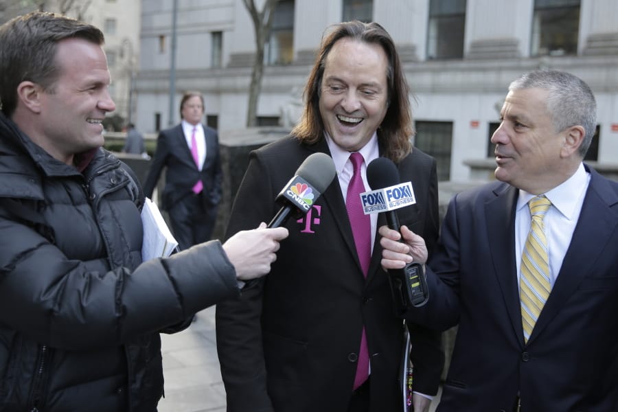FILE - In this Jan. 15, 2020, file photo T-Mobile chief executive John Legere speaks to reporters as he leaves the courthouse in New York. A federal judge has removed a major obstacle to T-Mobile&#039;s $26.5 billion takeover of Sprint, as he rejected claims by a group of states that the deal would mean less competition and higher phone bills.