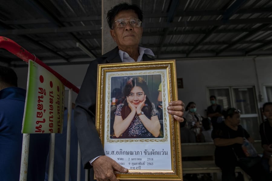 Khunpol Khanpakwan holds a portrait of his daughter Apiksanapa Khanpakwan outside a hospital morgue in Nakhon Ratchasima, Thailand, Monday, Feb. 10, 2020. It&#039;s still unclear how a Thai soldier managed to steal heavy weapons from an army base which he then used to kill 29 people and hold off security forces for almost 16 hours while he was holed up in a popular shopping mall. That he could do so is less surprising, experts in military matters say.