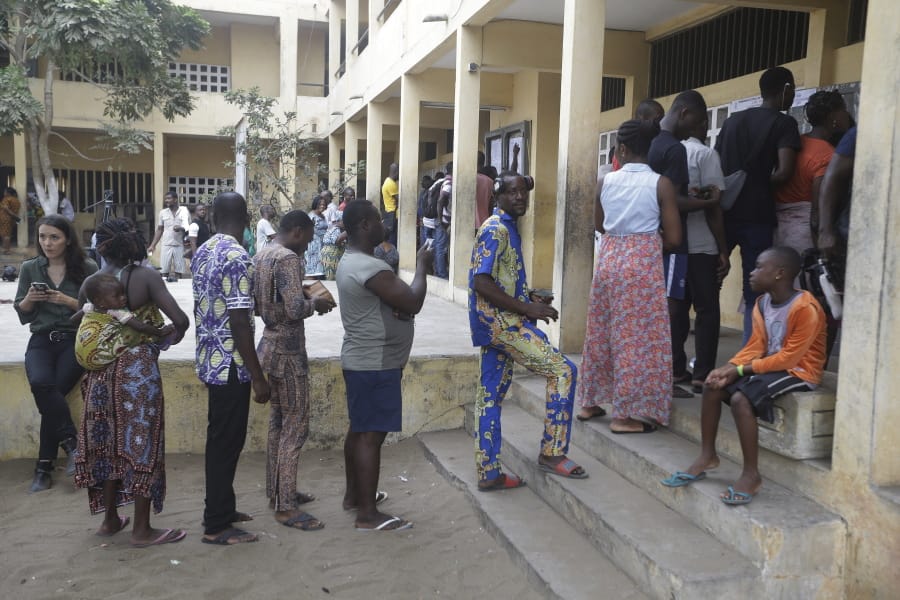 People wait to cast their votes in the presidential election in Lome, Togo, Saturday, Feb. 22, 2020. The West African nation of Togo is voting Saturday in a presidential election that is likely to see the incumbent re-elected for a fourth term despite years of calls by the opposition for new leadership.