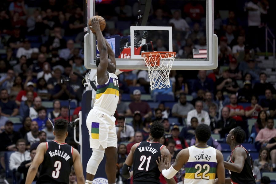 New Orleans Pelicans forward Zion Williamson (1) dunks the ball against the Portland Trail Blazers in the first half of an NBA basketball game in New Orleans, Tuesday, Feb. 11, 2020.