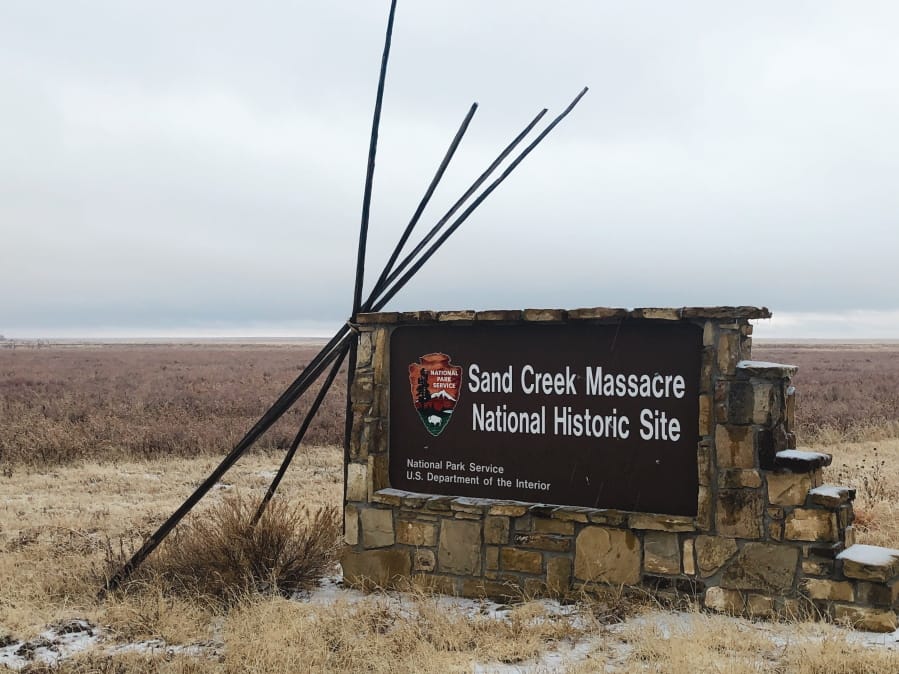In this Dec. 27, 2019, photo, an entrance sign is shown at the Sand Creek Massacre National Historic Site in Eads, Colo. This quiet piece of land tucked away in rural southeastern Colorado seeks to honor the 230 peaceful Cheyenne and Arapaho tribe members who were slaughtered by the U.S. Army in 1864. It was one of worst mass murders in U.S. history.