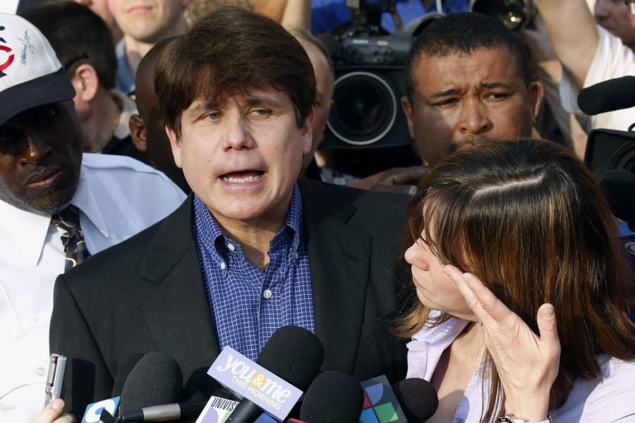 FILE - In this March 14, 2012, file photo, former Illinois Gov. Rod Blagojevich speaks to the media outside his home in Chicago as his wife, Patti, wipes away tears a day before reporting to prison after his conviction on corruption charges. President Donald Trump is expected to commute the 14-year prison sentence of Blagojevich. The 63-year-old Democrat is expected to walk out of prison later Tuesday, Feb. 18, 2020. (AP Photo/M.