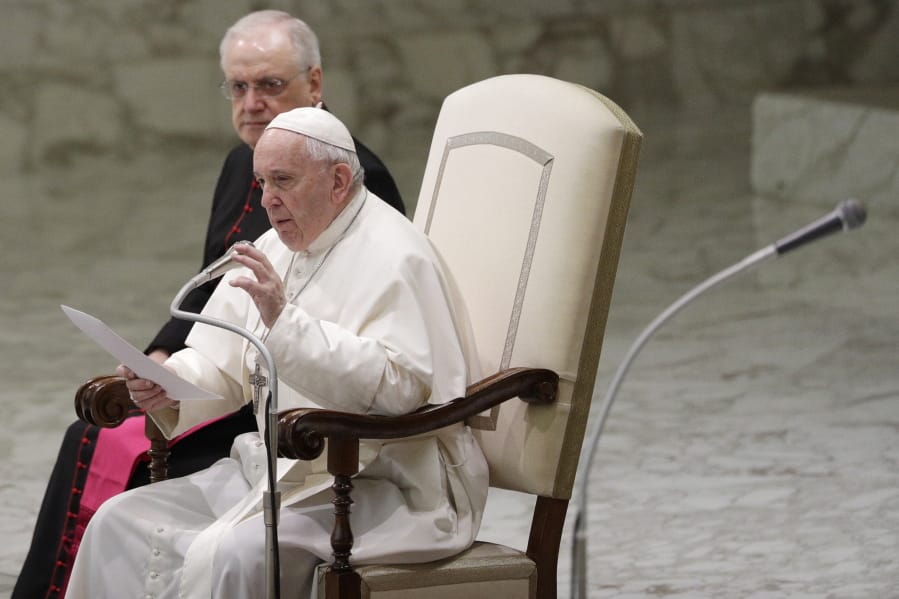 Pope Francis reads his message during the weekly general audience Wednesday at the Vatican.