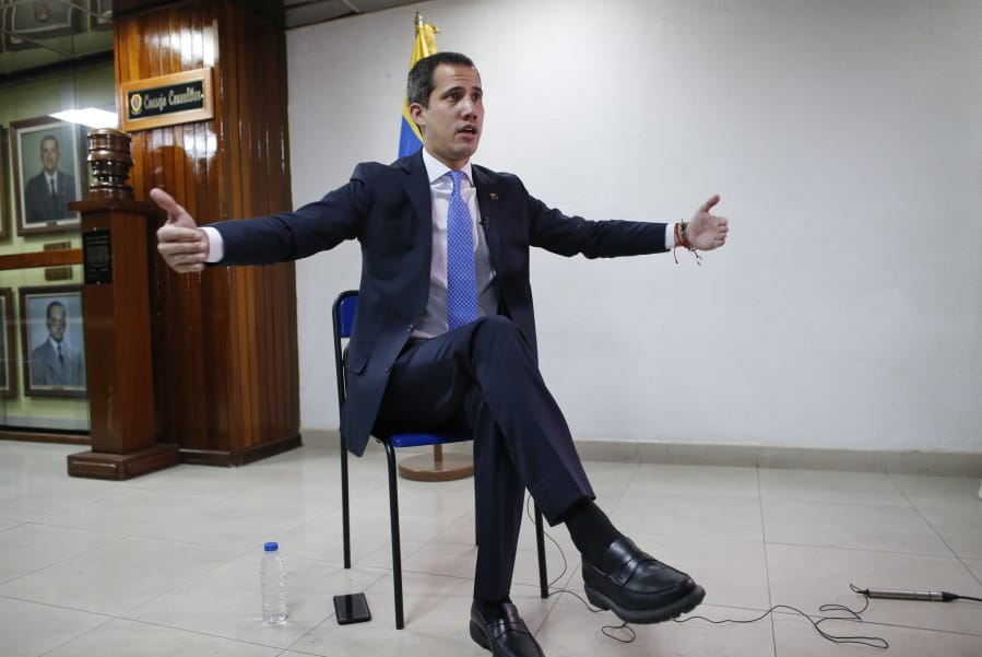 Opposition leader Juan Guaido gestures during an interview with the Associated Press in Caracas, Venezuela, Friday, Feb. 21, 2020.