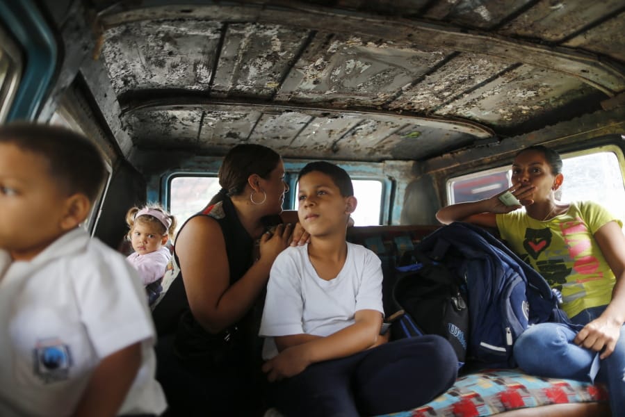 Passengers ride on public transport in Caracas, Venezuela, Wednesday, Feb. 19, 2020. The debate over fresh U.S. sanctions aimed at forcing out Venezuela&#039;s Nicolas Maduro played out Wednesday across the crisis-stricken South American nation. Families have been split up with at least 4.5 million Venezuelans fleeing crumbling public services.