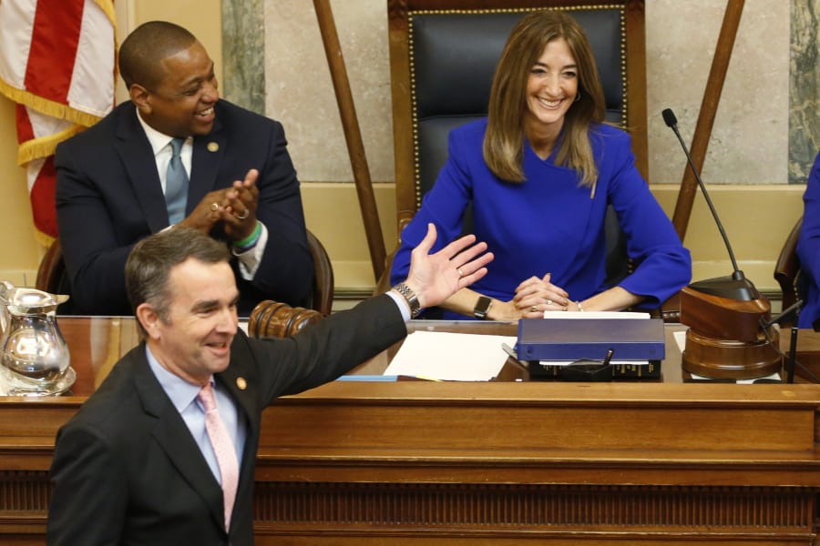 FILE - This Wednesday Jan. 8, 2020 file photo shows Virginia Gov. Ralph Northam, bottom left, as he recognizes House speaker, Eileen Filler-Corn, D-Farifax, right, while he prepares to deliver his State of the Commonwealth address as Lt. gov. Justin Fairfax, top left, applauds before a joint session of the Virginia Assembly at the Virginia state Capitol in Richmond, Va.