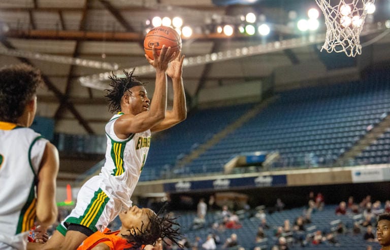 Evergreen's Zyell Griffin is called for a charging foul on his way to the rim in a 3A round-of-12 game on Wednesday at the Tacoma Dome. Rainier Beach won 61-52 to end the Plainsmen's season.