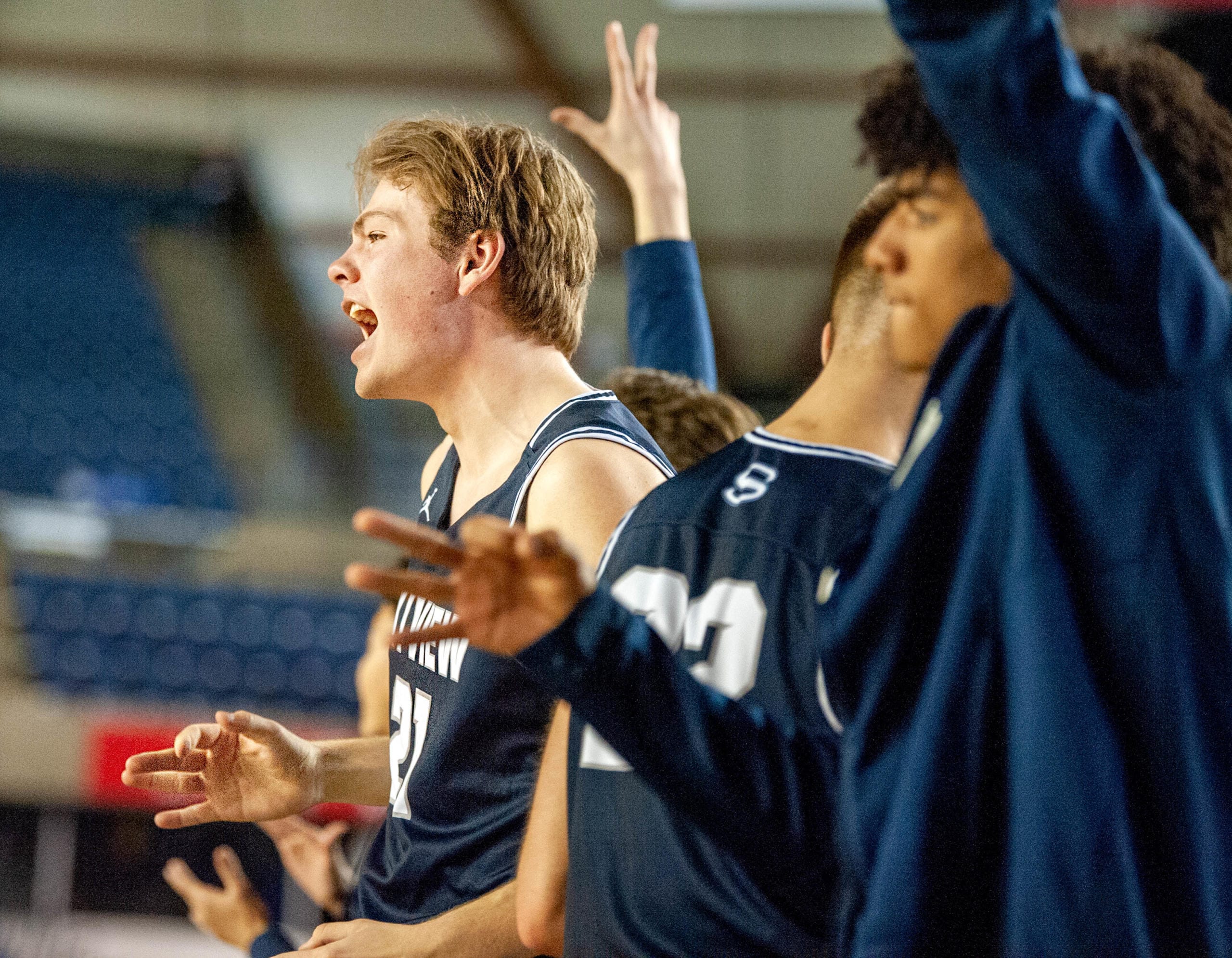 Skyview's Cole Bain, left, celebrates a Jace Chatman 3-pointer with his teammates on the bench during Skyviews' 47-31 victory over West Valley of Yakima in a 4A round-of-12 game Wednesday at the Tacoma Dome.
