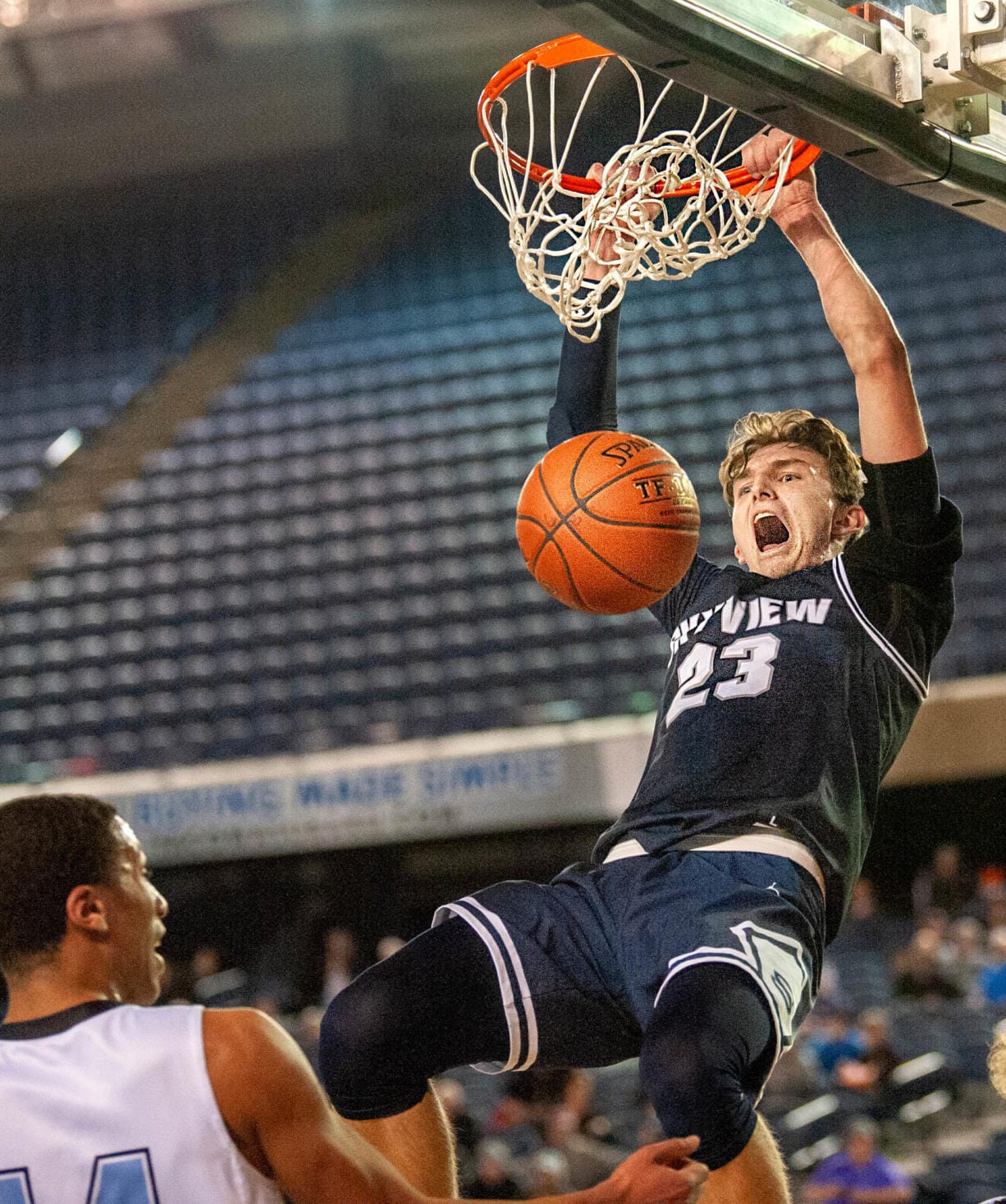 Skyview's Kyle Gruhler slams home a dunk in a 4A State quarterfinal on Thursday at the Tacoma Dome.  The Storm lost 65-64.