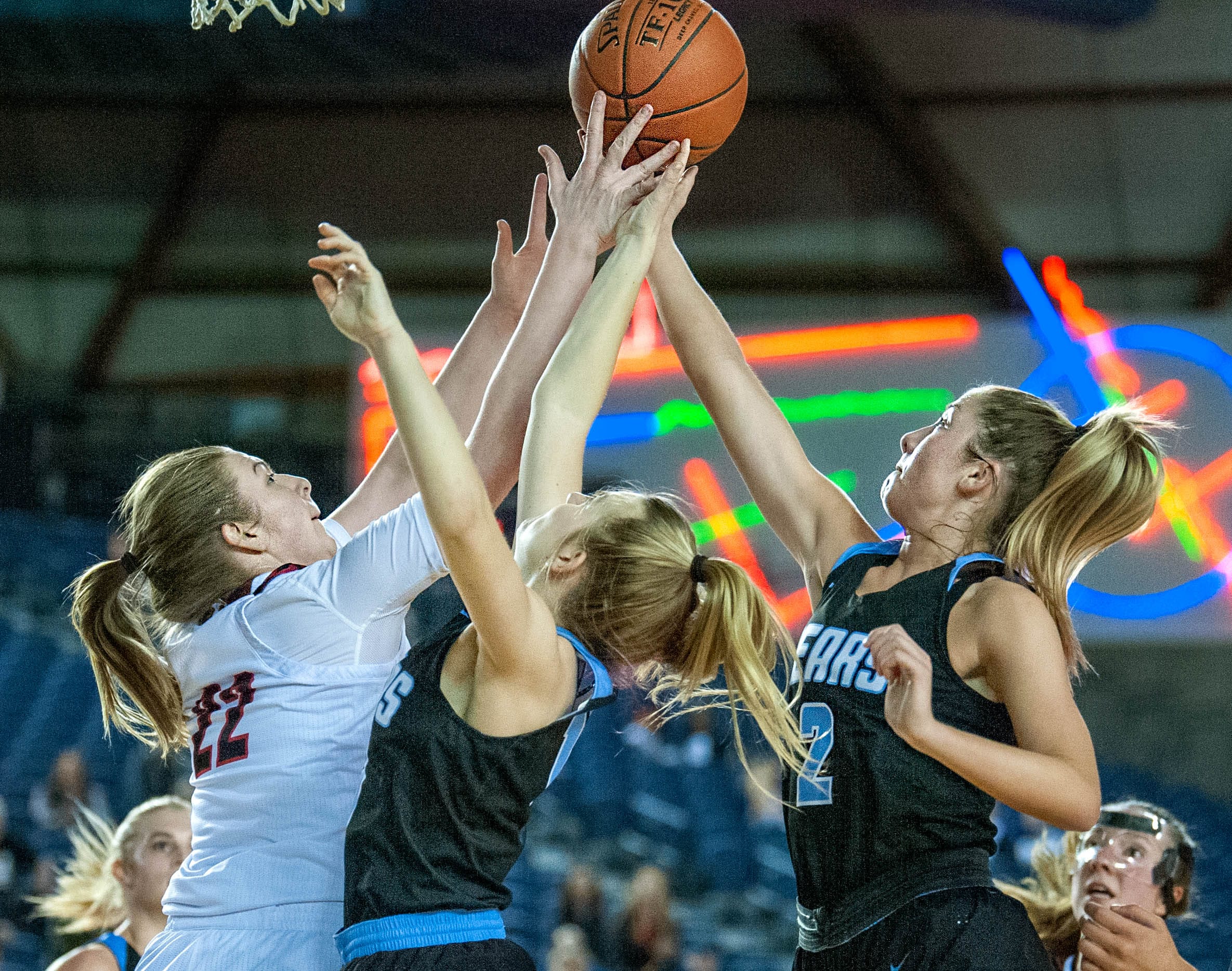 Union's Mackenzie Lewis fights for a rebound with Central Valley's Anika Chalich, center, and Michael Pitts, right. The Titans lost 61-53 in the 4A State semifinal Friday at the Tacoma Dome.