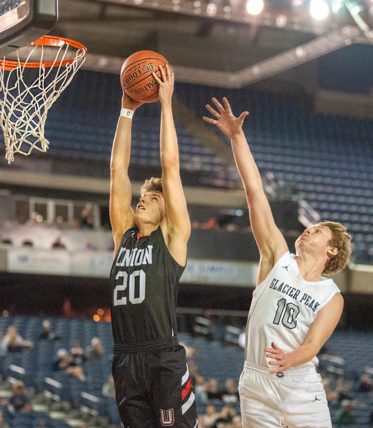Union's Josh Reznick rises up for a dunk as Glacier Peak's Tristan Bates tries to defend in the TItans' 63-49 in the 4A State trophy game on Saturday at the Tacoma Dome.