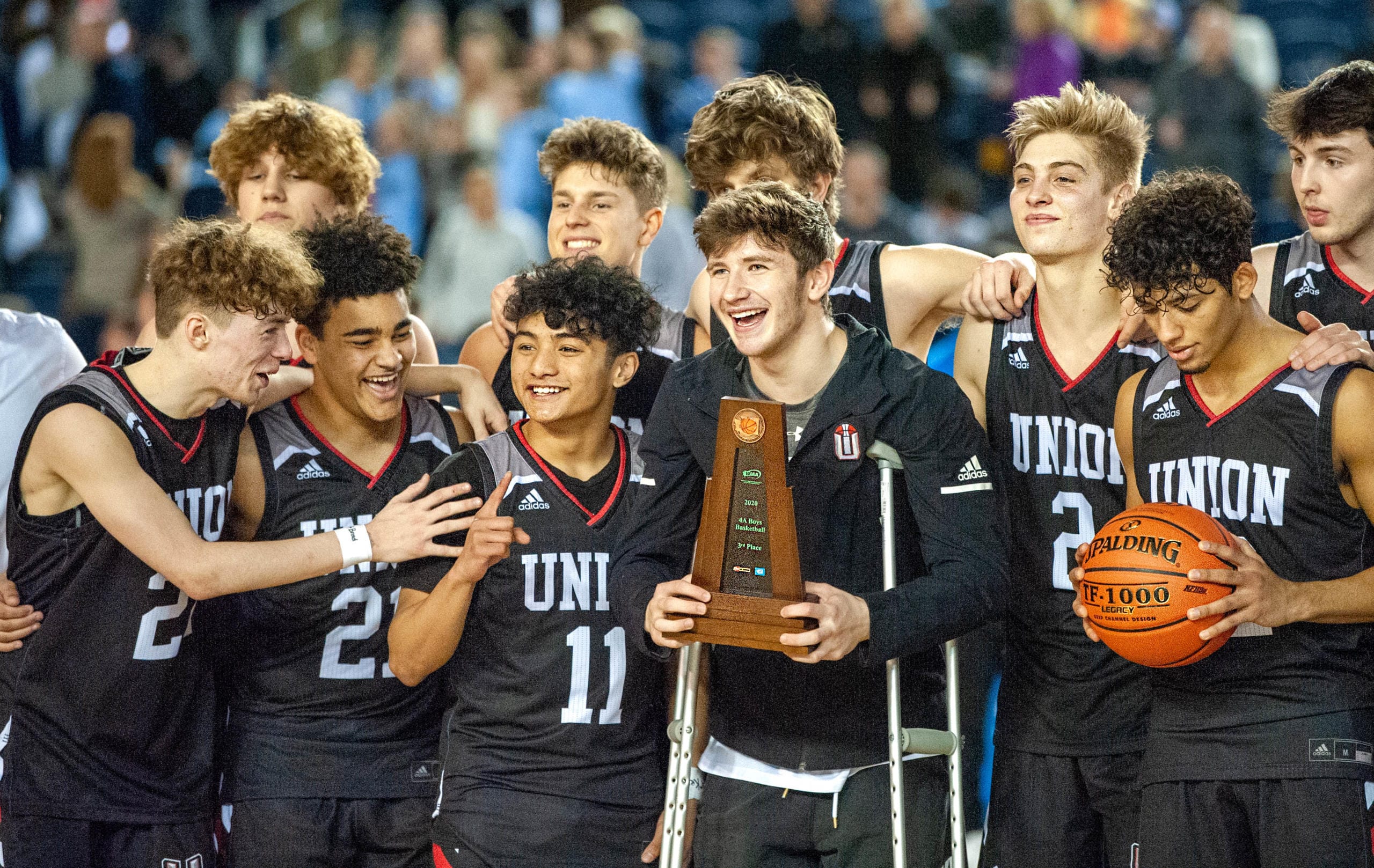 Union players, from left to right (front row) Kaden Horn, Jamison Limbrick, Izaiah Vongnath, Tanner Toolson and Ariya Briscoe celebrate their third-place trophy on Saturday at the Tacoma Dome.