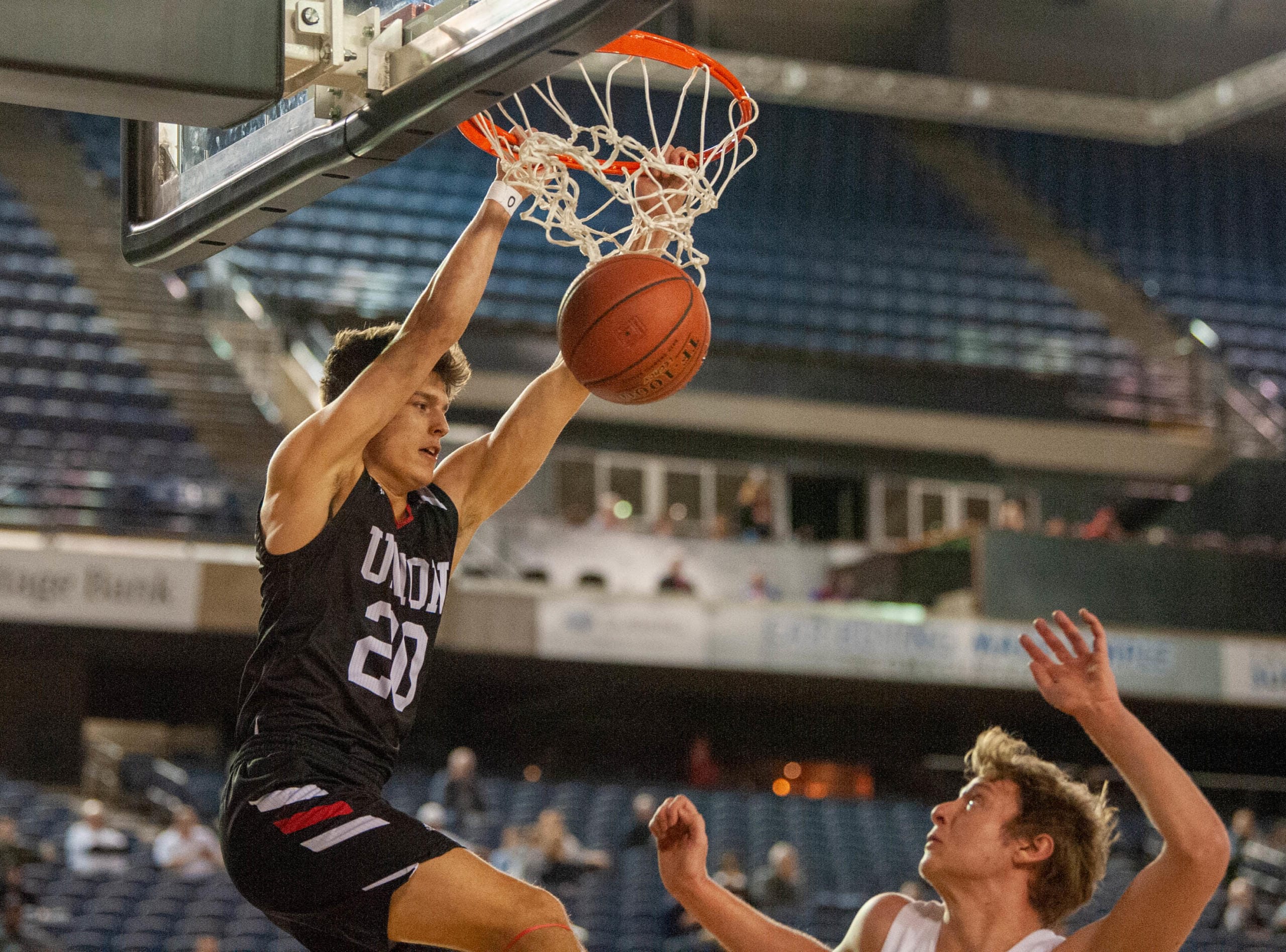 Union's Josh Reznick finishes his dunk in a 4A State trophy game Saturday at the Tacoma Dome. Union finished third.