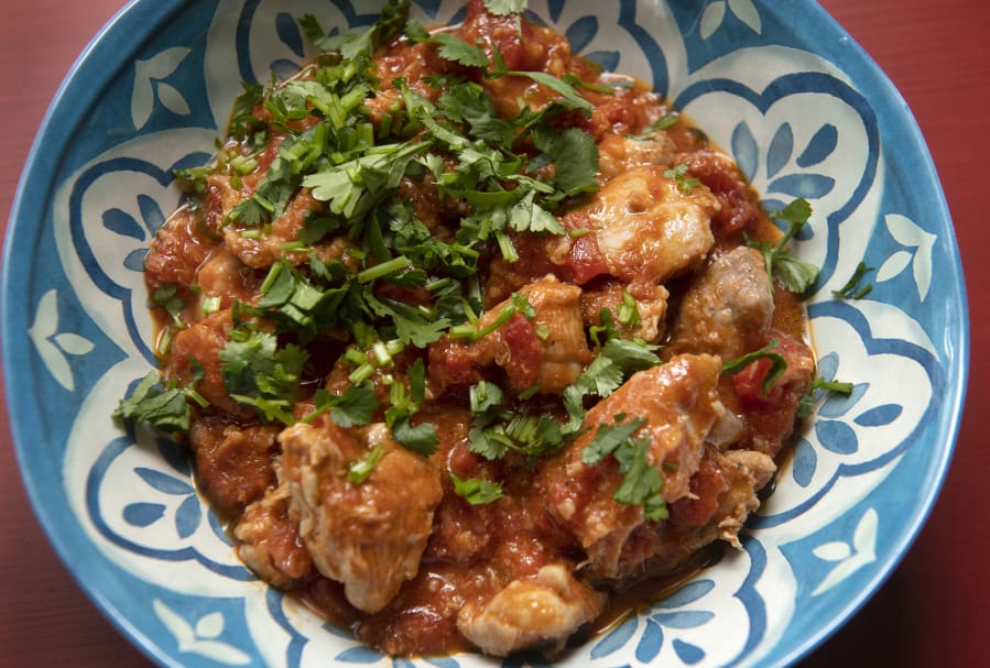 Kenyan coconut chicken is made with tomatoes and coconut milk and flavored with ginger, garlic and ground coriander.