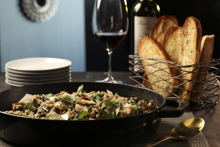 Mushroom risotto, paired with an arugula-grape salad and crusty bread, is a delicious way to use up stockpiles of pantry treasures. Styled by Shannon Kinsella.