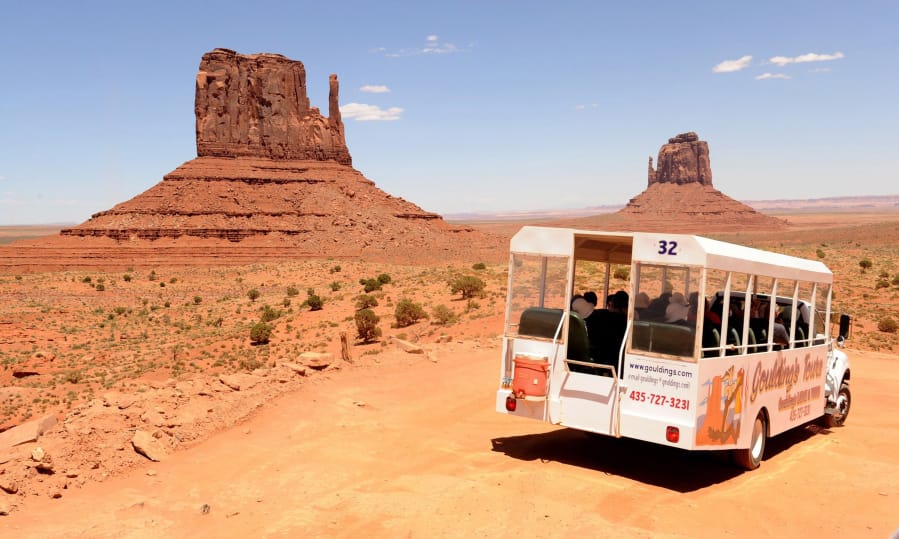 A tourist bus stops for a view of Monument Valley on the Utah/Arizona border.