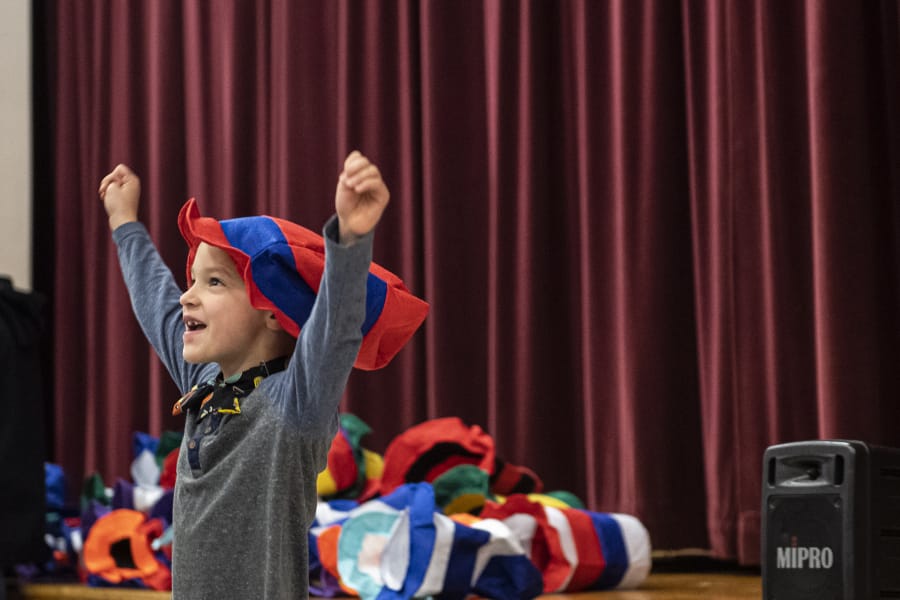 Henry Boge reacts to receiving a Dr. Seuss hat during Read Across America Day at Chinook Elementary School on Monday morning.