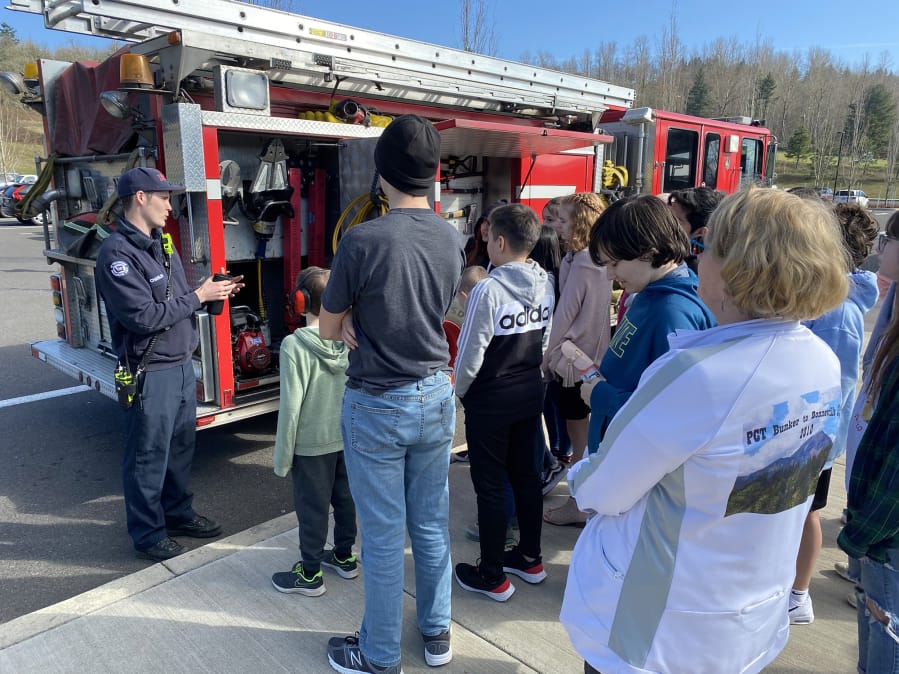 WASHOUGAL: EMT Nollan Charles talks with Jemtegaard Middle School students at their annual career fair.