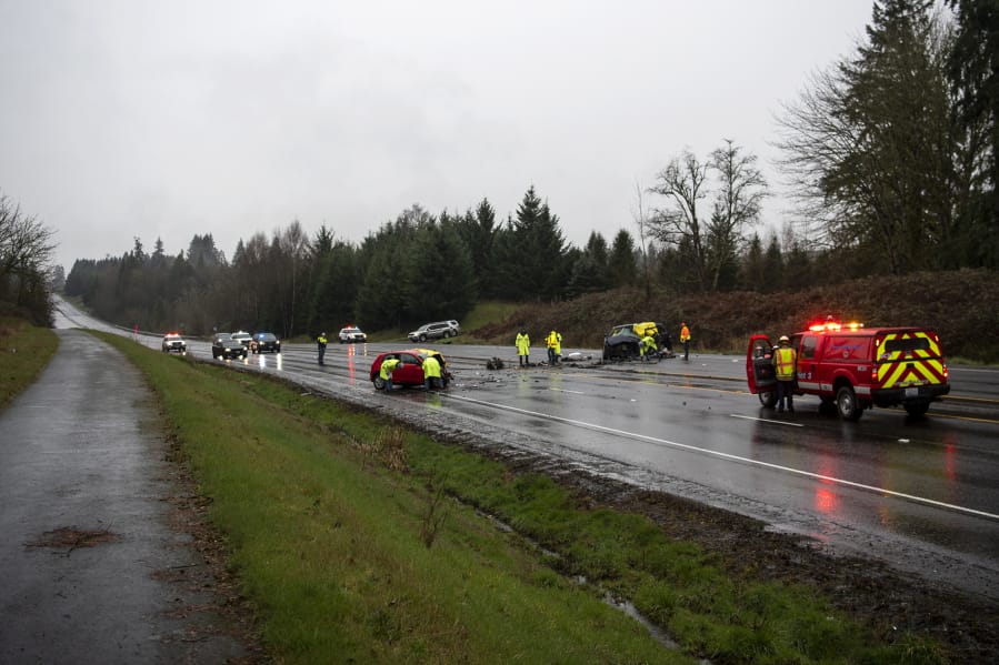 All lanes of state Highway 503 in Brush Prairie are blocked while law enforcement investigates a crash that killed three people and critically injured two children on Friday. The red car was traveling northbound on Highway 503 and tried to pass traffic on the left using the southbound lane, hitting the minivan head-on, according to the Washington State Patrol.