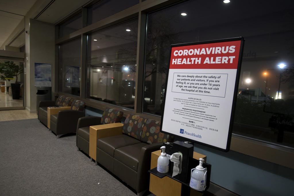 A coronavirus health alert sign is posted at one of the entrances to the Firstenburg Tower at PeaceHealth Southwest Medical Center on Monday morning, March 9, 2020.