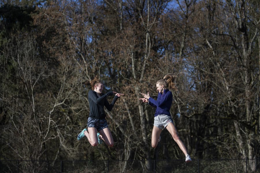 High jumpers Jerrica Pachl, left, and Ellie Saunders, are good friends and teammates at Seton Catholic. They also finished first and second at state last year.