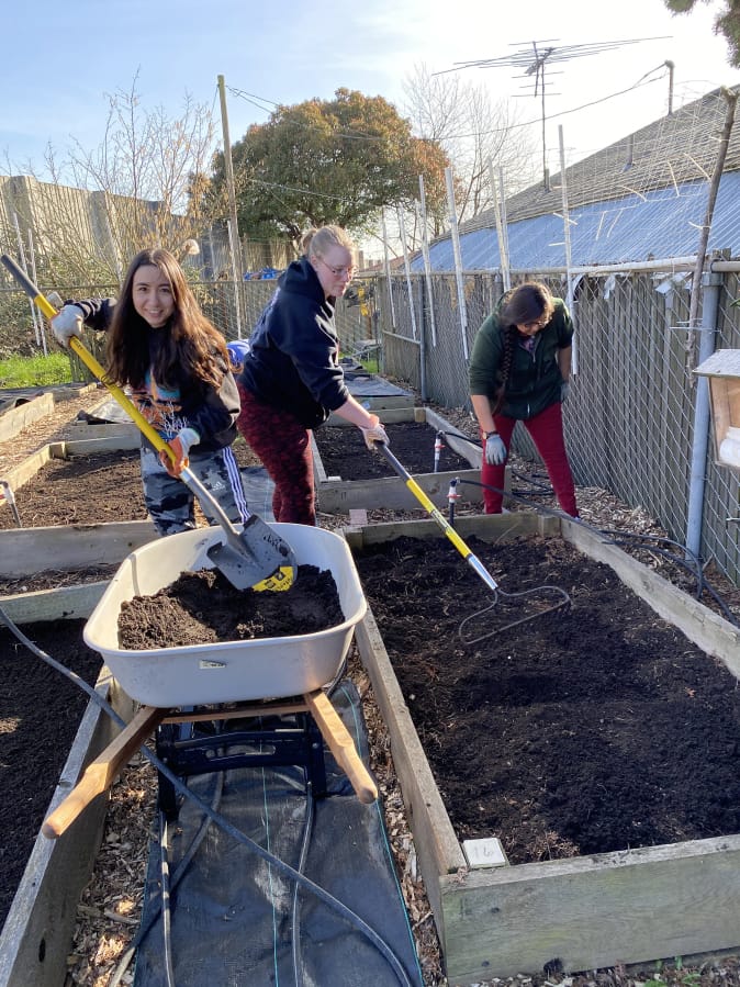 HAZEL DELL: From left, Karmia Keffer, Megan Ulrich, and Deborah Cronemeyer work at the Hazel Dell School and Community Garden. Thirty-seven Clark College student made a difference by helping prepare garden for spring.