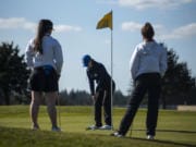 Ridgefield golfer Samantha Fenton putts during a match against Union at Tri Mountain Golf Course on Thursday.