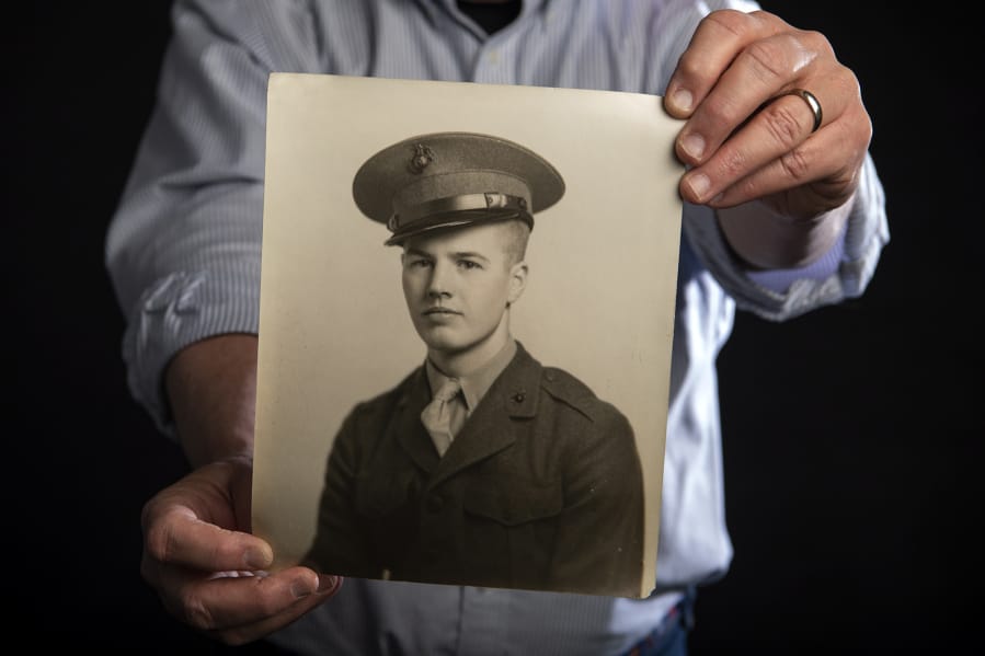 Jeff Osborne holds a photo of his father, Bill Osborne, taken around 1943. Marine Cpl. Bill Osborne trained for the battle of Iwo Jima at Parker Ranch in Hawaii.