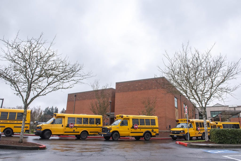 Buses line up to transport students from Covington Middle School on March 13, 2020.