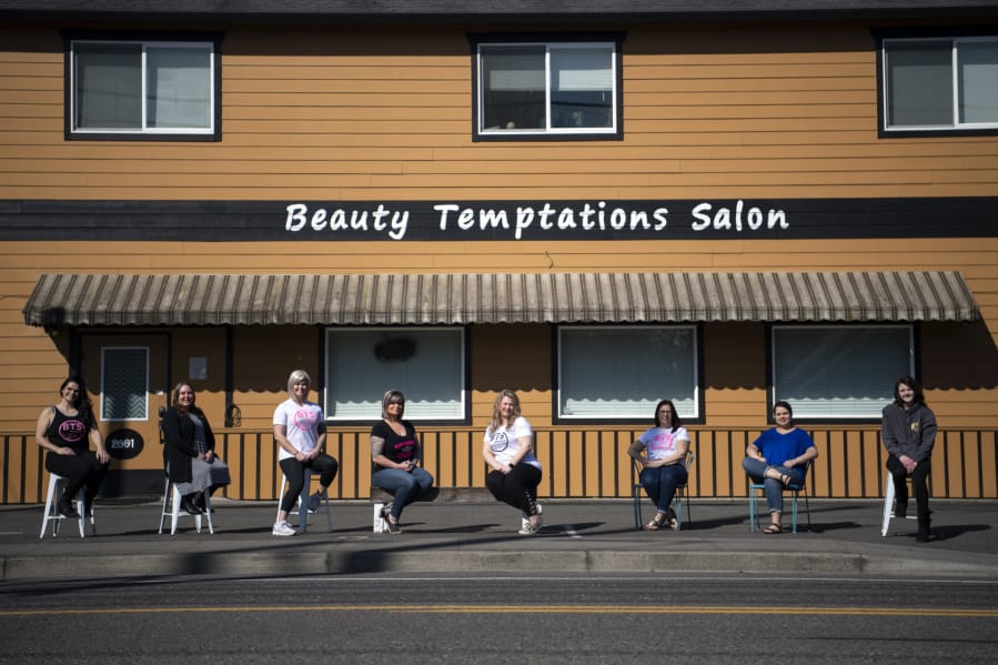 The Beauty Temptations Salon cosmetologists are pictured in Washougal on Thursday. The women had to shutter the salon Tuesday after the COVID-19 outbreak forced closures of salons across the state, effectively putting eight self-employed cosmetologists out of business.