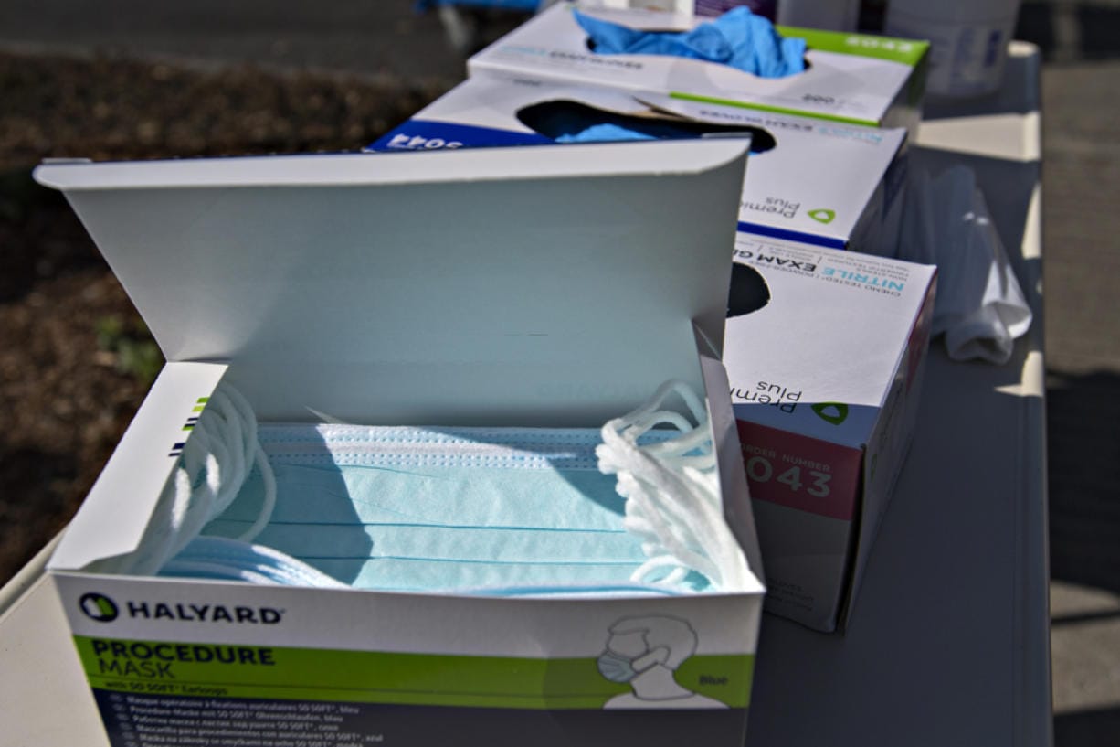 A box of procedure masks sits next to boxes of gloves as staff awaits COVID-19 patients at PeaceHealth Southwest Medical Center on Friday afternoon.