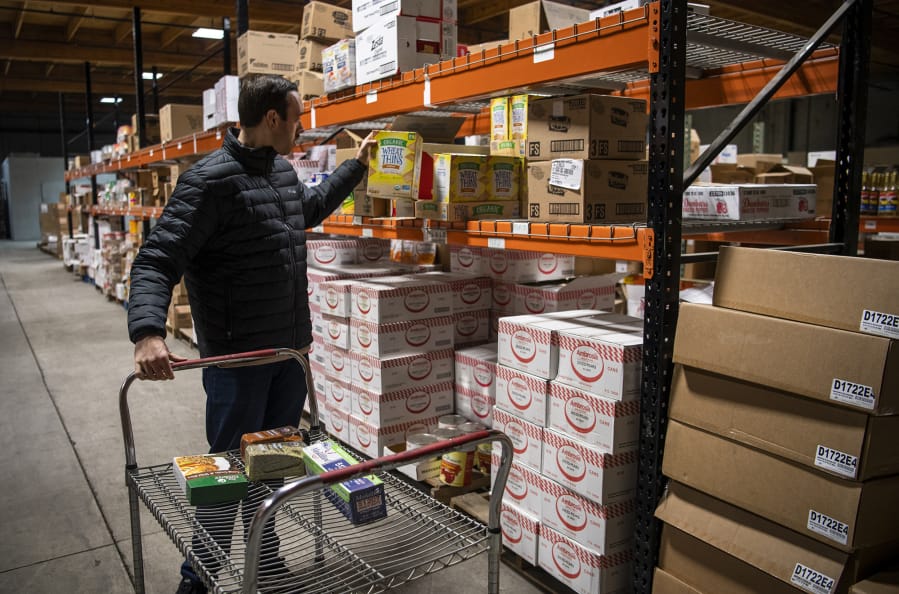 Tim Boris of Ridgefield picks out items at SteBo&#039;s Food Service in Vancouver on Friday. Normally SteBo&#039;s only sells in bulk to restaurants and stores, but the company is temporarily selling to individual buyers, too.