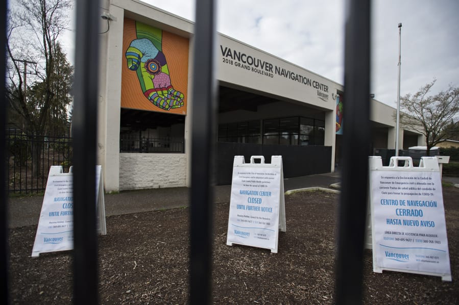 Signs outside the Vancouver Navigation Center in March 2020 notify visitors of the closure due to COVID-19 concerns.
