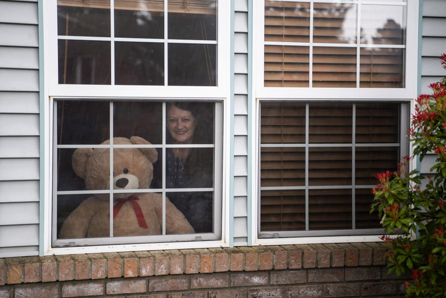 Alisha Jucevic/The Columbian
Cheryl Zander of Vancouver&#039;s Lincoln neighborhood with a teddy bear she propped in her front window. Her daughter is now an adult, but Zander enjoys watching the delight of neighborhood children when they spot the stuffed animals on their &quot;bear hunts.&quot; (Alisha Jucevic/The Columbian)