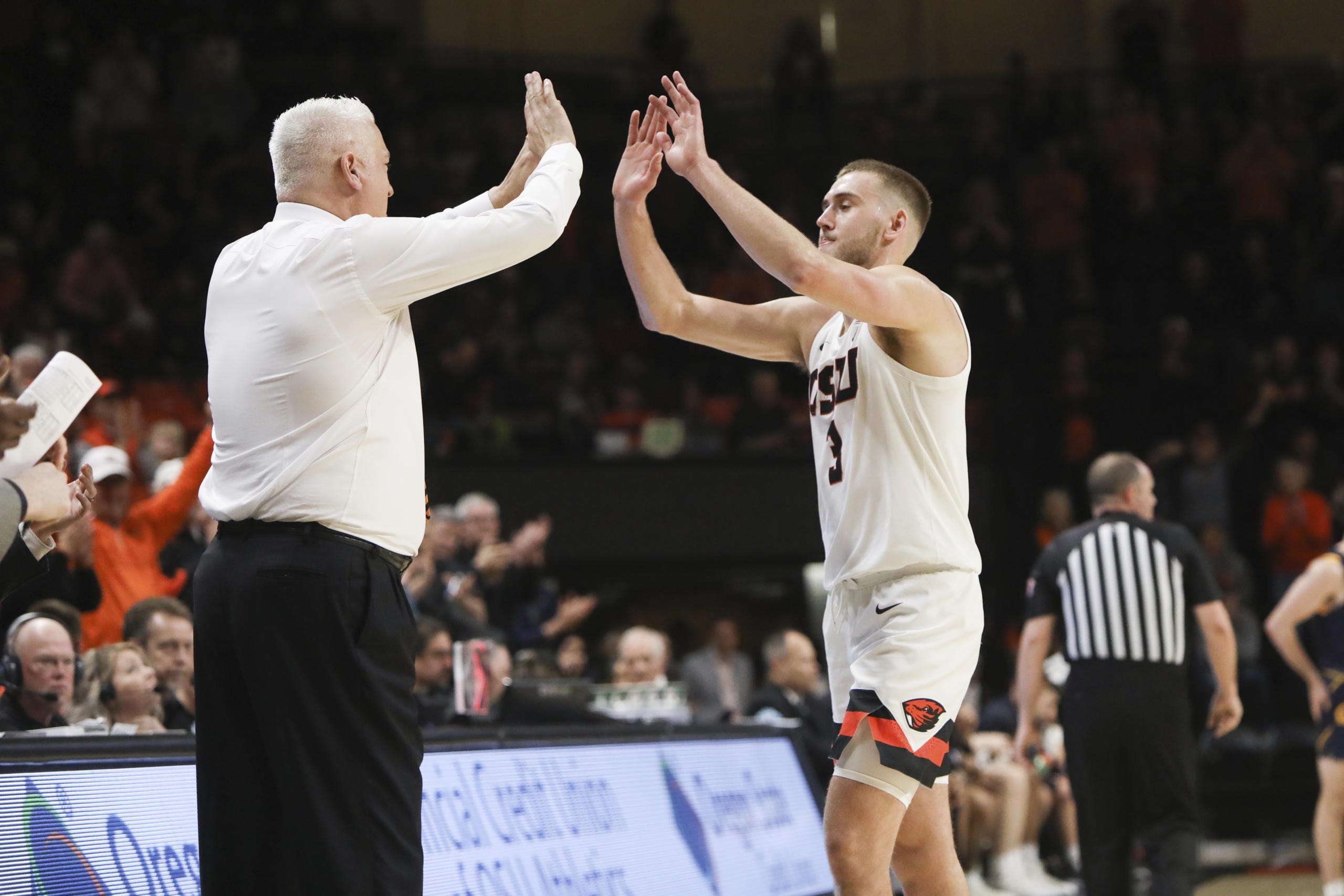 Oregon State's Tres Tinkle (3) high-fives his father, Oregon State head coach Wayne Tinkle, as Tres is subbed out in the last minute of his final home NCAA college basketball game, against California, in Corvallis, Ore., Saturday, March 7, 2020.