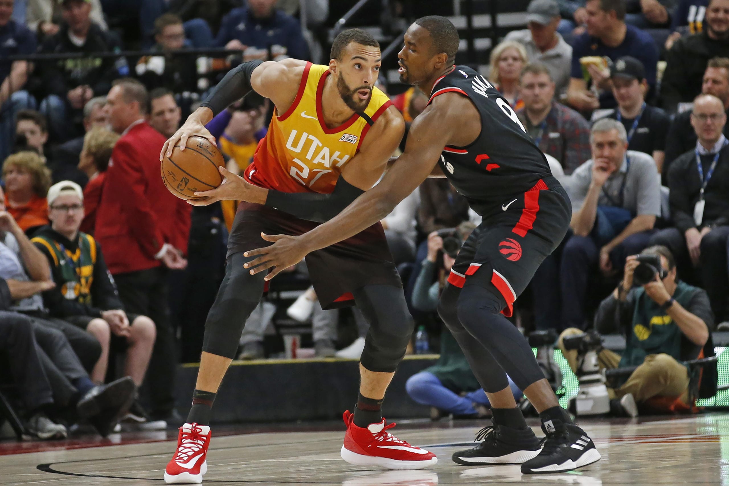 Toronto Raptors center Serge Ibaka (9) guards against Utah Jazz center Rudy Gobert (27) in the first half during an NBA basketball game Monday, March 9, 2020, in Salt Lake City.