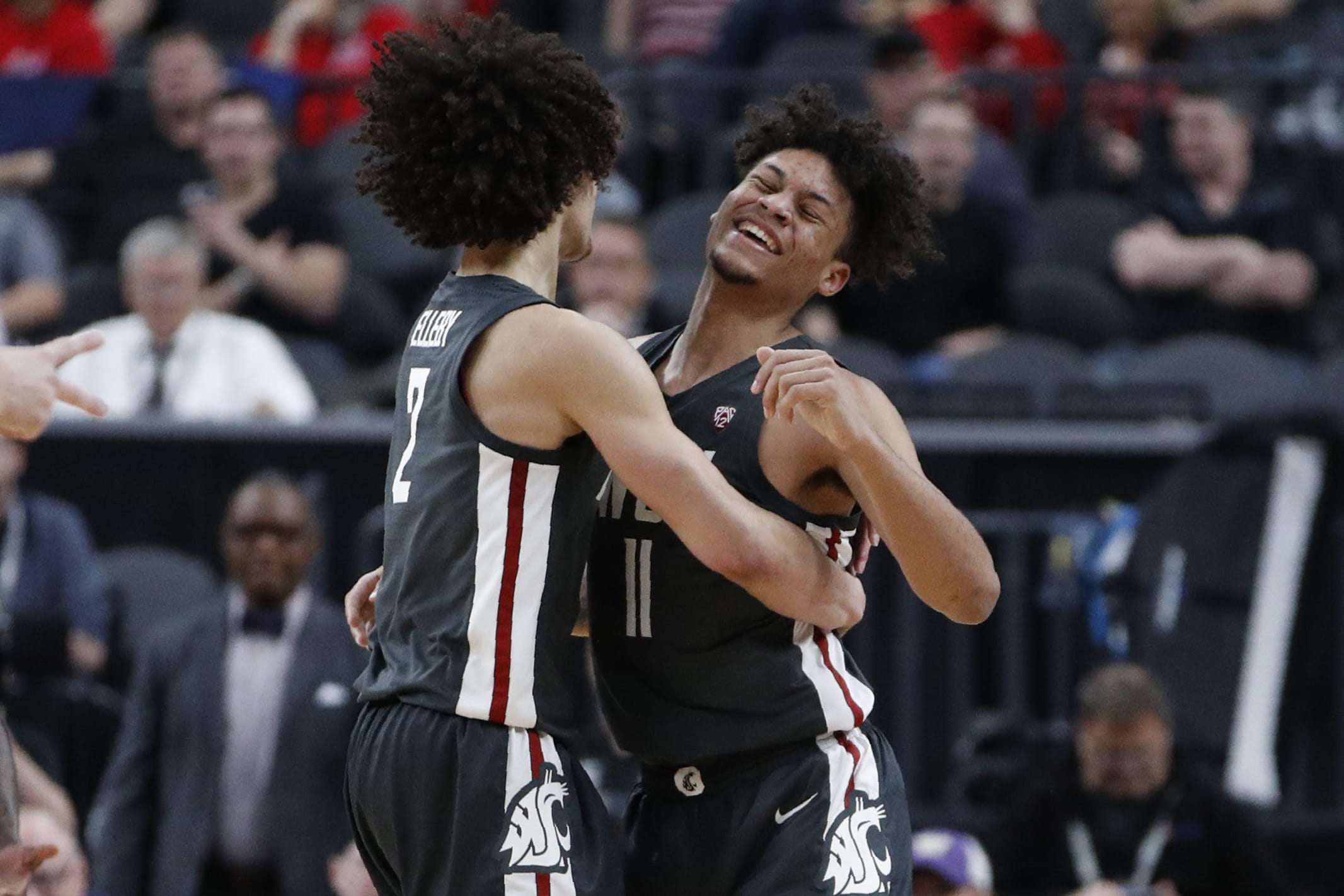 Washington State's CJ Elleby, left, and DJ Rodman celebrate after a play against Colorado during the second half of an NCAA college basketball game in the first round of the Pac-12 men's tournament Wednesday, March 11, 2020, in Las Vegas.