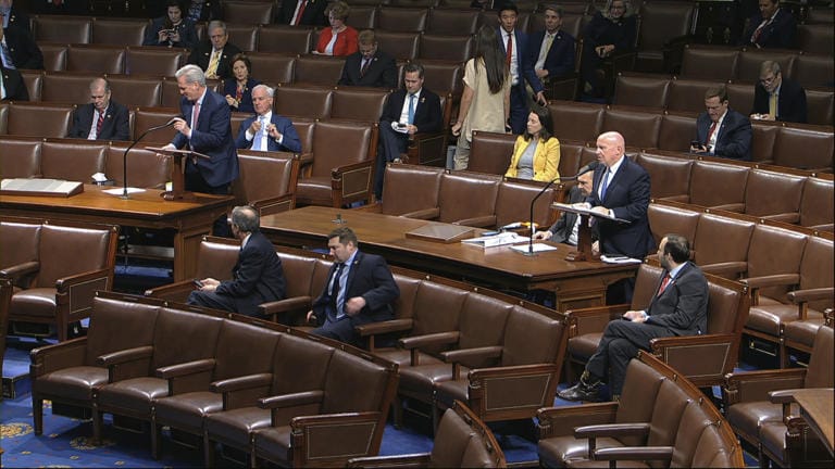 In this image from video, Rep. Kevin McCarthy, R-Texas, left, and Rep. Kevin Brady, R-Texas, stand as they speak on the floor of the House of Representatives at the U.S. Capitol in Washington, Friday, March 27, 2020.