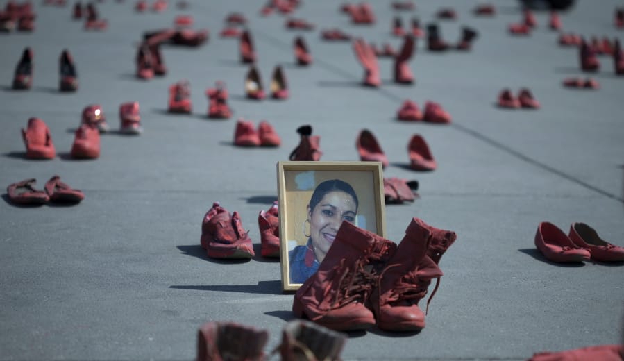A portrait of Eugenia Machuca Campos, who was slain by her boyfriend, is surrounded by an installation of red women&#039;s shoes in a protest against gender violence Jan. 11  in Mexico City.