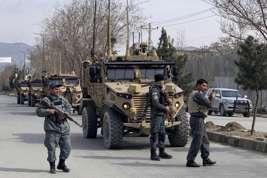 Foreign security personnel and Afghan police arrive at the site of an attack in Kabul, Afghanistan, Friday, March 6, 2020.