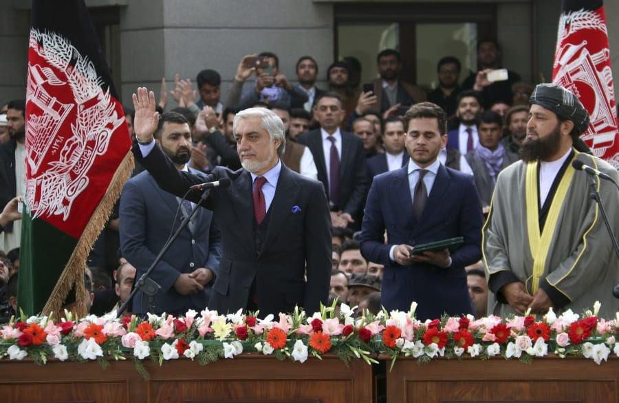 In this Monday, March 9, 2020, photo, Afghanistan&#039;s Abdullah Abdullah, front left, greets his supporters after being sworn in as president in Kabul, Afghanistan. Washington moved forward Tuesday on its peace deal with the Taliban, launching its troop withdrawal, while praising Afghanistan&#039;s newly installed President Ashraf Ghani&#039;s promise to proceed with a Taliban prisoner release as well as cobble together a team to start negotiations with the insurgent group. But the dueling presidential inaugurations a day earlier with Ghani&#039;s rival, Abdullah Abdullah also being sworn in as president is indicative of the uphill task facing Washington&#039;s peace envoy Zalmay Khalilzad as he tries to get Afghanistan&#039;s bickering leadership to come together.